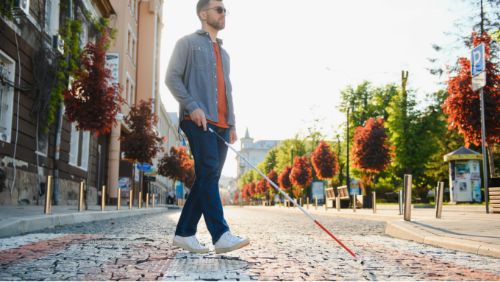 Mallorca excursion destinations: Man exploring the city with a white cane. Mallorca excursion destinations: Man exploring the city with a white cane.