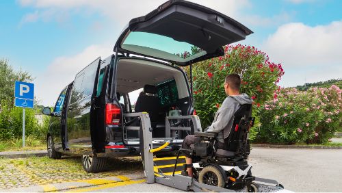 Renting an accessible car: Wheelchair user enters the vehicle using a ramp.
